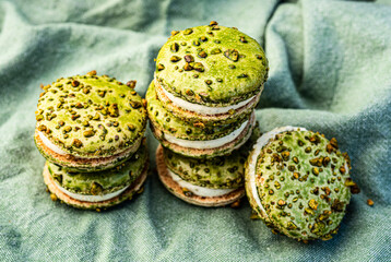 stacks of green color pistachio macaron cream filled sandwich cookies - 532537814