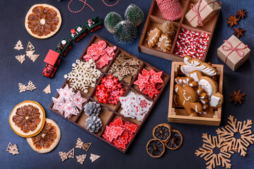 Christmas tree wooden toys in white and red colors, gingerbread and dried lemon and grapefruit slices