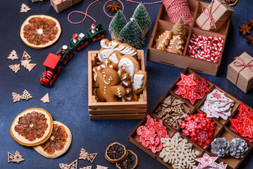 Christmas tree wooden toys in white and red colors, gingerbread and dried lemon and grapefruit slices