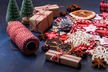Christmas tree wooden toys in white and red colors, gingerbread and dried lemon and grapefruit slices