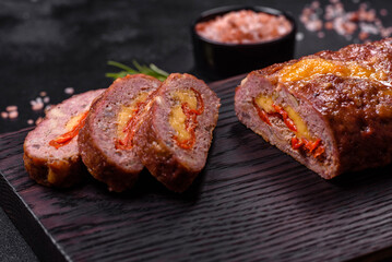 Delicious fresh ground beef meat roll with cheese, tomatoes and sweet peppers