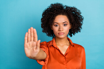 Photo of serious confident lady hand palm demonstrate stop gesture isolated on blue color background