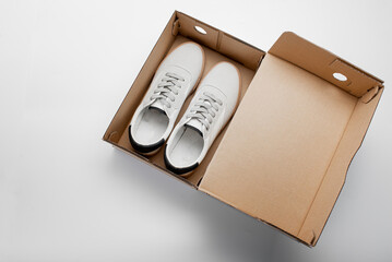 New shoes in a cardboard box. Casual white sneakers