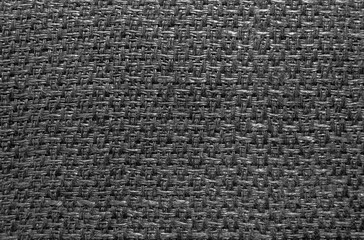 Textile. The texture is black with straight lines and weave. Close-up of household towel material