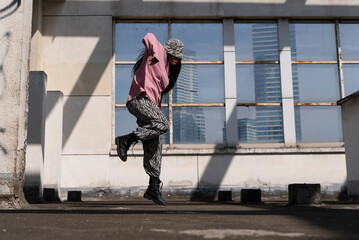 young woman hip hop dance on the roof