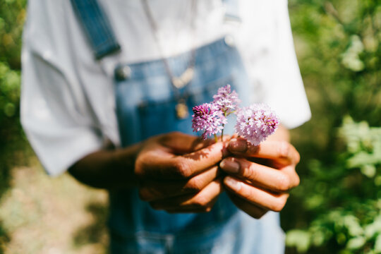 A Woman Holds Wildflowers