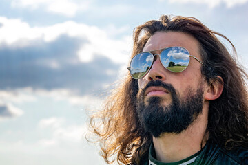 Man wearing sunglasses riding a retro motorbike