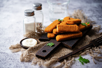 Fresh prepared fish sticks with sauce