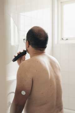 Diabetic man shaving.