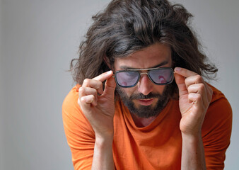Young man wearing sunglasses in studio