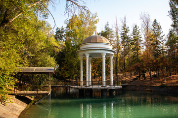 beautiful gazebo on the pond. autumn landscape near the water