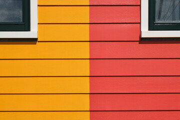 Detail photo of painted wood and windows of some Scandinavian like colored houses in Zoutkamp, The...
