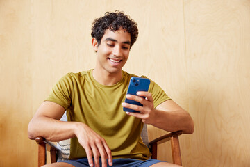 Merry athlete browsing social media during break