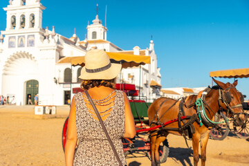 Fototapeta premium A tourist with horses at the El Rocio sanctuary at the Rocio festival, Huelva. Andalusia