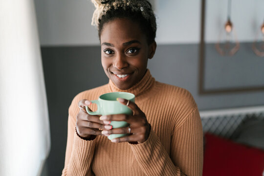 Delighted Black Woman With Coffee At Home