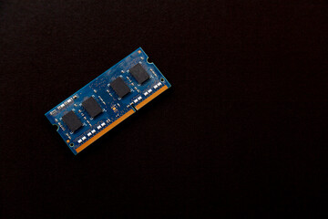 Computer memory chip placed on top of a black table. Connections and circuits on display. Chip concept. Technology concept.