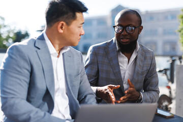 Man helping colleague with project 