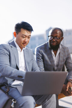 Man helping colleague with creative project 