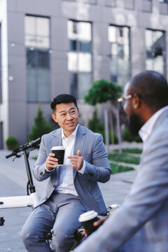 Worker enjoying beverage during lunch with workmate