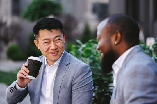 Employer having coffee break with workmate 