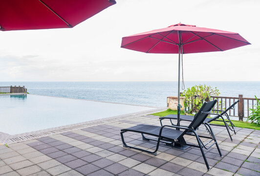 Infinity swimming pool with beach lounger for vacation and relax