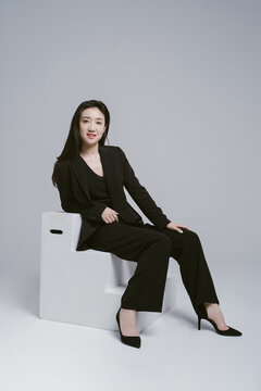 Portrait of young woman wearing suit
