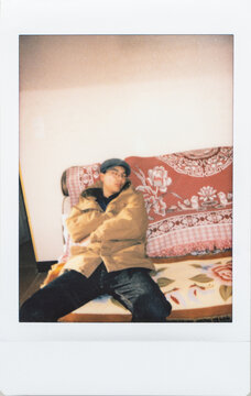 Polaroid photo of young man sleeping at home