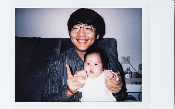 Polaroid photo of father and newborn baby girl 
