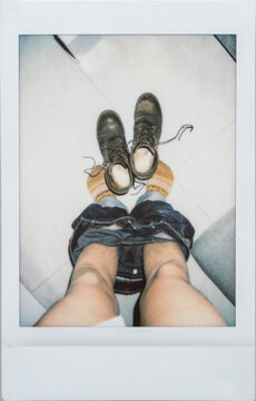 Polaroid Photo Of Man Taking Off Pants And Shoes