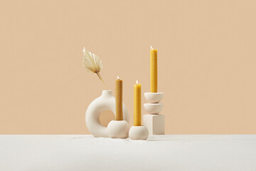 Composition of burning yellow beeswax candles.