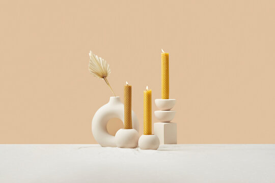 Composition of burning yellow beeswax candles.