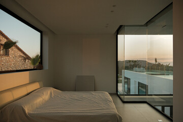 Interior of modern bedroom with glass wall