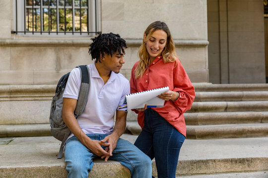 Two Friends University Students review assignment on steps 