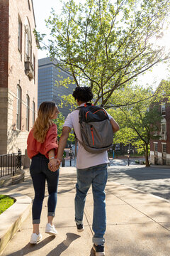 Two cute Friends University Students flirt and hold hands 