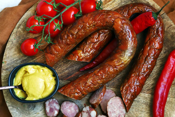 Chopped smoked sausages. Fresh homemade sausages on a wooden board.