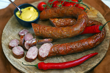 Chopped smoked sausages. Fresh homemade sausages on a wooden board.