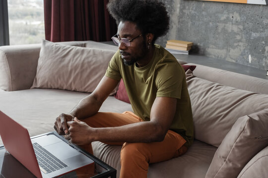 Nervous black man listening to boss online