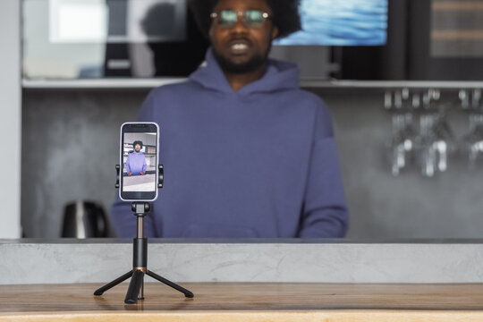 Lifestyle blogger shooting video on smartphone