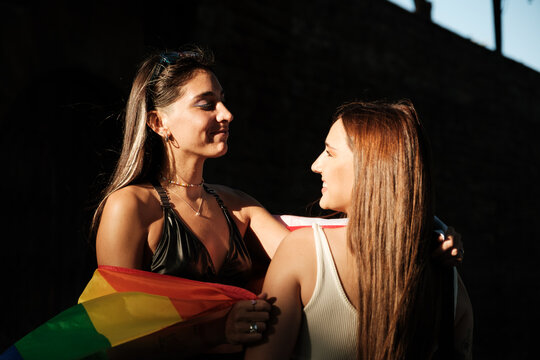 Proud lesbian couple looking each other 