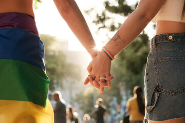 Anonymous lesbian couple holding hands at pride