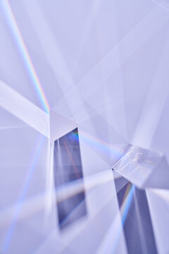 Triangular glass prisms with light and rainbow.