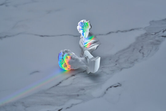 Antique statues with abstract prism rainbow.