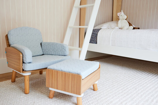 Small child's chair in bedroom with bunkbed