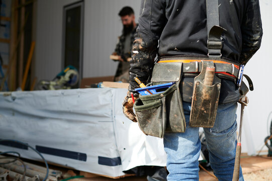 Builder wearing tool belt