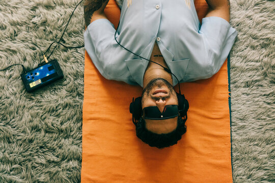Handsome Young Man Using Brain Stimulation Machine at Home