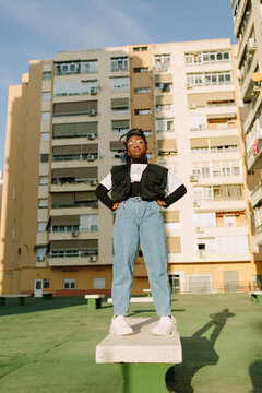 Young Woman Standing Up Above A Bench