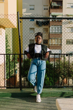 Young girl leaning on a railing in the street