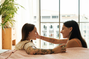 Lesbian couple caressing at home