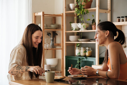 Lesbian couple having breakfast in the kitchen - Powered by Adobe