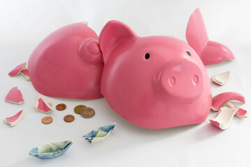 Piggy bank symbol of inflation, economy and crisis. Pink coloured on white background